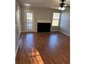 Living room featuring hardwood floors, fireplace, and backyard access at 128 Waters Edge Way, Fayetteville, GA 30215