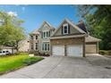 Two-story house with stone and shingle accents, two-car garage, and landscaped yard at 5175 Ivy Green Way, Smyrna, GA 30126