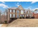 Two story home with a brick facade and mature trees at 2155 Washington Dr, Douglasville, GA 30135