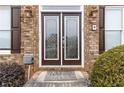 Double front doors with beveled glass and a welcome mat at 2155 Washington Dr, Douglasville, GA 30135