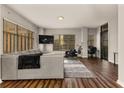 Bright living room with a modern gray sectional sofa, large windows, and a view of the city at 565 Peachtree Ne St # 804, Atlanta, GA 30308