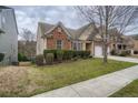 Side view of house showcasing landscaping and driveway at 1077 Balvaird Dr, Lawrenceville, GA 30045