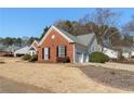 Brick ranch home with a two-car garage and manicured lawn at 2490 Insdale Nw Trce, Acworth, GA 30101