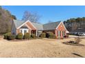 Brick ranch home with mature shrubs and a large yard at 2490 Insdale Nw Trce, Acworth, GA 30101