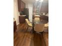 Kitchen with dark wood cabinets and glass table at 500 Gristmill Ln, Hampton, GA 30228