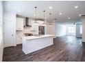 Modern white kitchen with stainless steel appliances and island at 5215 Riden Ct, Buford, GA 30518