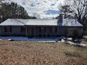 Gray siding ranch home with red shutters and snow on the roof at 3295 Highway 138 Ne, Conyers, GA 30013