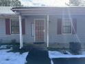 House exterior with gray siding, red shutters, and a snow-covered porch at 3295 Highway 138 Ne, Conyers, GA 30013