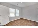 Simple bedroom with wood flooring and neutral walls at 5337 Tolar Rd, South Fulton, GA 30213