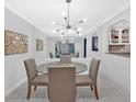 Bright dining room with modern light fixture, mirrored wall and a view into the kitchen at 6851 Roswell Rd # J1, Atlanta, GA 30328