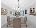 Bright dining room features a modern light fixture, neutral paint, and an opening to a galley kitchen at 6851 Roswell Rd # J1, Atlanta, GA 30328