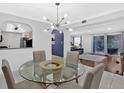 Open concept dining area featuring modern chandelier and open view to the living room at 6851 Roswell Rd # J1, Atlanta, GA 30328