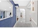 Inviting entry with white tile floors, archways and views to the living room with blue accent wall at 6851 Roswell Rd # J1, Atlanta, GA 30328