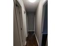 Long hallway with dark hardwood floors and doors to bedrooms at 794 Old Allatoona Se Rd, Cartersville, GA 30121