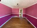 Simple dining room with hardwood floors and pink walls at 5174 Stone Trce, Stone Mountain, GA 30083
