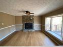 Living room with stone fireplace and hardwood floors at 5174 Stone Trce, Stone Mountain, GA 30083