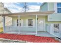 Charming front porch with white railings and red mulch at 6137 Raleigh Oaks Ct, Lithonia, GA 30058