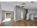 Spacious living room with hardwood floors and a view of the dining area and kitchen at 6137 Raleigh Oaks Ct, Lithonia, GA 30058