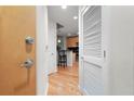 Bright hallway with hardwood floors leading to the kitchen and white doors at 250 Pharr Ne Rd # 607, Atlanta, GA 30305