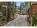 Stone driveway leading to home through wrought iron gates at 1790 Garraux Nw Rd, Atlanta, GA 30327