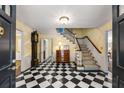 Checkerboard floor entryway with staircase and antique furniture at 1790 Garraux Nw Rd, Atlanta, GA 30327