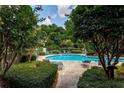 Community pool with lounge chairs and lush landscaping at 507 Embers Se Dr, Marietta, GA 30067