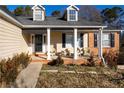 Covered front porch with seating area and brick columns at 540 Flint Ridge Ct, Jonesboro, GA 30238