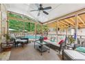 Cozy screened porch overlooking the pool, furnished for relaxation at 2505 Ridgehurst Dr, Buford, GA 30518