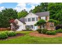 Charming two-story home with manicured landscaping and decorative community sign at 42 Millstone Gln, Dallas, GA 30157