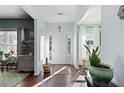 Bright foyer with hardwood floors, white trim, and decorative plants at 42 Millstone Gln, Dallas, GA 30157