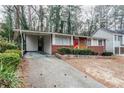 Brick ranch home with red door and carport at 2848 Baker Ridge Nw Dr, Atlanta, GA 30318