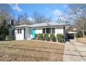 Charming updated home with a turquoise front door, showcasing curb appeal at 2131 Ben Hill Rd, Atlanta, GA 30344