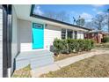 Inviting front entrance with a teal door and gray steps leading to the home at 2131 Ben Hill Rd, Atlanta, GA 30344