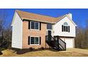 Two-story house with brick and vinyl siding, two-car garage, and a landscaped yard at 256 Kings Cv, Locust Grove, GA 30248