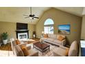 Living room with hardwood floors, fireplace, and staged furniture at 256 Kings Cv, Locust Grove, GA 30248