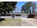 Single-story home with a front yard, a car port in the rear, and neutral paint scheme at 1988 Glenmar Dr, Decatur, GA 30032