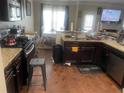 Spacious kitchen featuring granite countertops and dark wood cabinets at 3746 Wood Hollow Way, Snellville, GA 30039