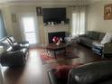 Living room with hardwood floors, fireplace, and comfortable seating at 3746 Wood Hollow Way, Snellville, GA 30039