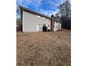 Rear view of a Ranch home with access to a storage area, showcasing the home's length at 6540 Old White Mill Rd, Fairburn, GA 30213