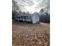 Side view of a Ranch style home showcasing the length of the house and backyard at 6540 Old White Mill Rd, Fairburn, GA 30213