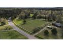 Aerial view of property showing house, fenced pastures, and wooded areas at 10170 Cedar Grove Rd, Chattahoochee Hills, GA 30213