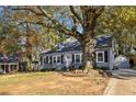 Gray house with white trim, large tree, and driveway at 2930 Kimmeridge Dr, Atlanta, GA 30344