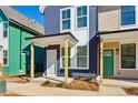 Front view of charming craftsman style home with light green and blue siding at 1095 Tucker Ave # 501, Atlanta, GA 30310