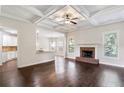 Spacious living room with hardwood floors, a brick fireplace, and coffered ceilings at 307 Cinnamon Bark Pass, Locust Grove, GA 30248