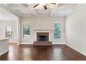 Living room with hardwood floors, brick fireplace and large windows at 307 Cinnamon Bark Pass, Locust Grove, GA 30248