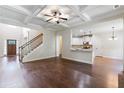 Open floor plan with hardwood floors, kitchen island, and staircase at 307 Cinnamon Bark Pass, Locust Grove, GA 30248