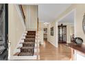 Bright entryway with hardwood floors, staircase, and view to living area at 4187 Westchester Ne Trce, Roswell, GA 30075