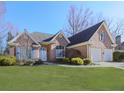 Brick house with a two-car garage and lush green lawn at 4251 Sheffield Nw Ct, Kennesaw, GA 30144