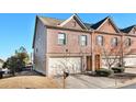 Two-story brick townhouse, attached garage, and yard at 7165 Fringe Flower Dr # 5, Austell, GA 30168