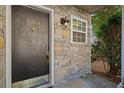 Dark brown front door with a brass door knocker and stone surround at 1004 Masons Creek Cir # 1004, Atlanta, GA 30350